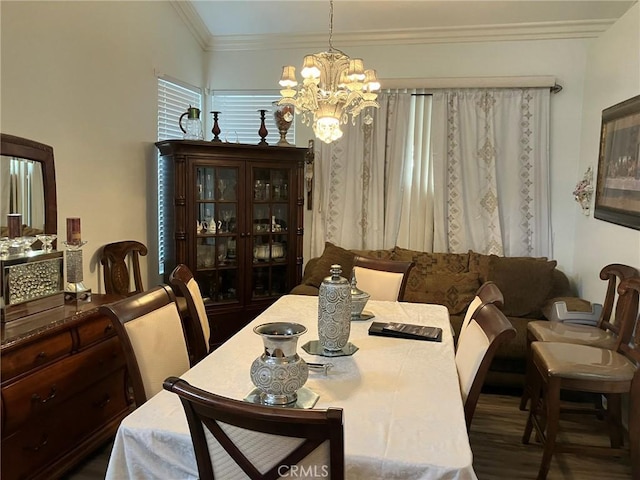 dining area with lofted ceiling, a chandelier, dark hardwood / wood-style floors, and ornamental molding