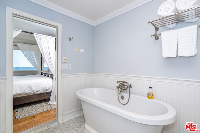 bathroom with tile patterned floors, a bathtub, and ornamental molding