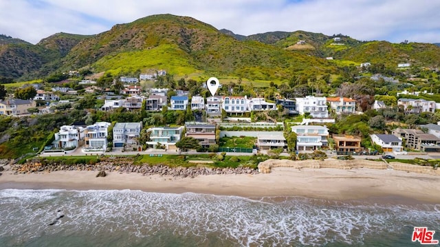 drone / aerial view with a water and mountain view