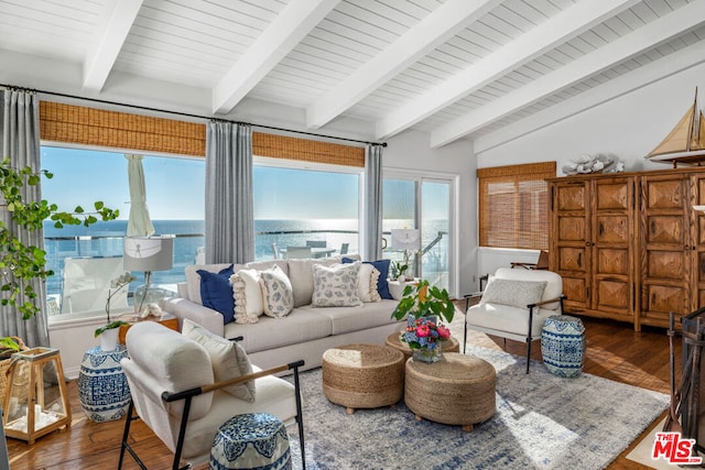 living room with wood-type flooring, vaulted ceiling with beams, and a water view