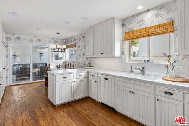 kitchen featuring white cabinets, plenty of natural light, and pendant lighting