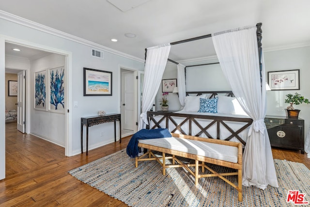 bedroom featuring hardwood / wood-style floors and ornamental molding