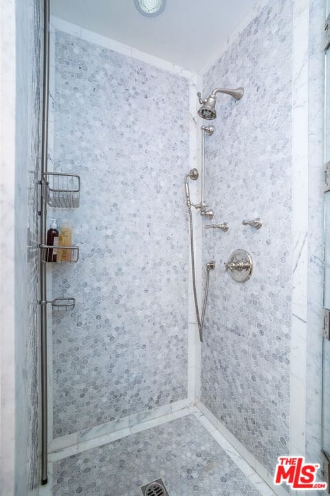 bathroom with a tile shower