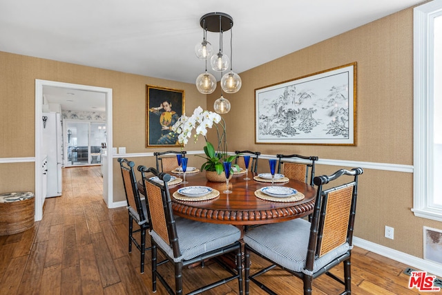 dining space with hardwood / wood-style floors