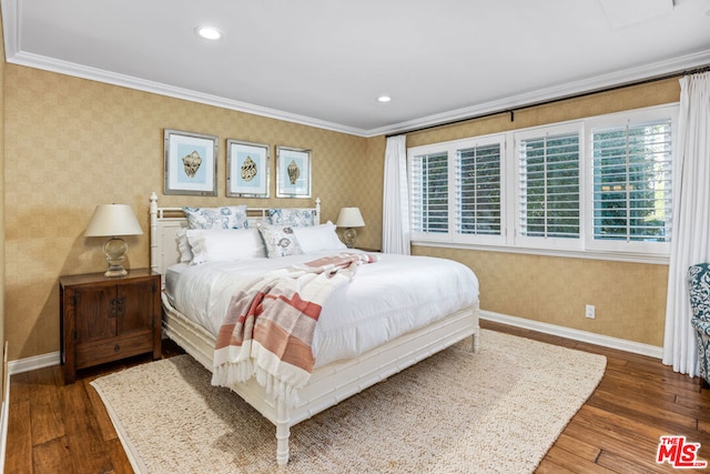 bedroom featuring crown molding and dark hardwood / wood-style floors