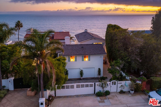 aerial view at dusk with a water view