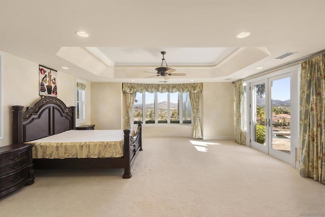 carpeted bedroom with access to outside, a raised ceiling, ceiling fan, and ornamental molding