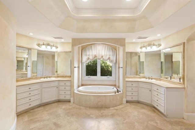 bathroom featuring a relaxing tiled tub, a raised ceiling, crown molding, and vanity