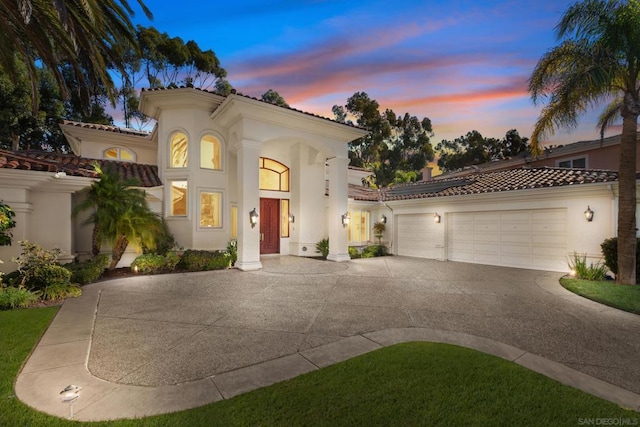 mediterranean / spanish-style house with a garage