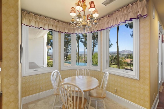 dining room featuring a mountain view and an inviting chandelier