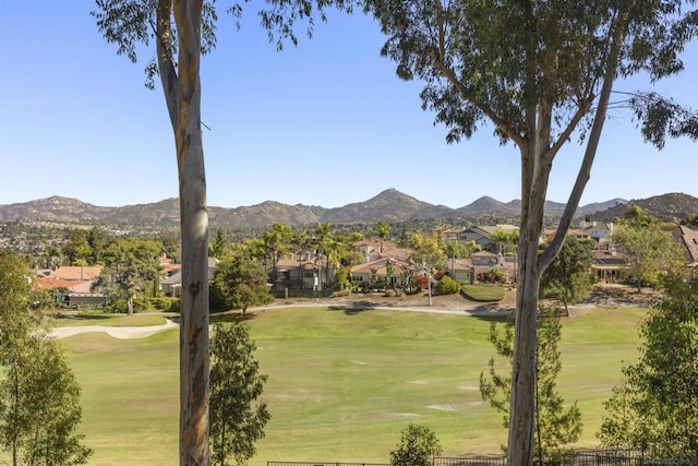 view of community featuring a mountain view and a lawn