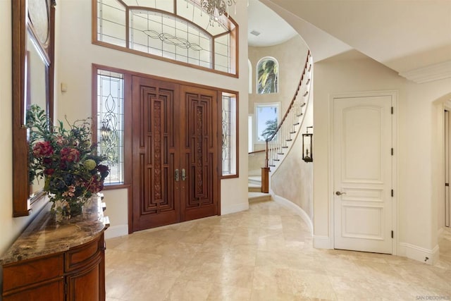 entrance foyer featuring a towering ceiling