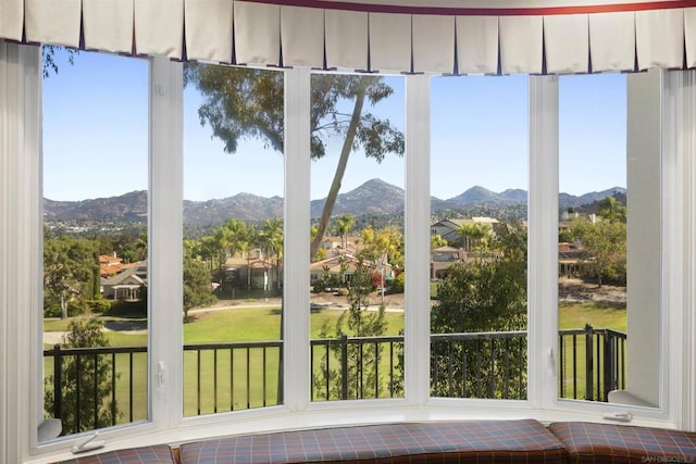 unfurnished sunroom with a mountain view and plenty of natural light