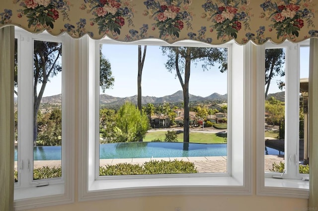 doorway with a mountain view and a wealth of natural light