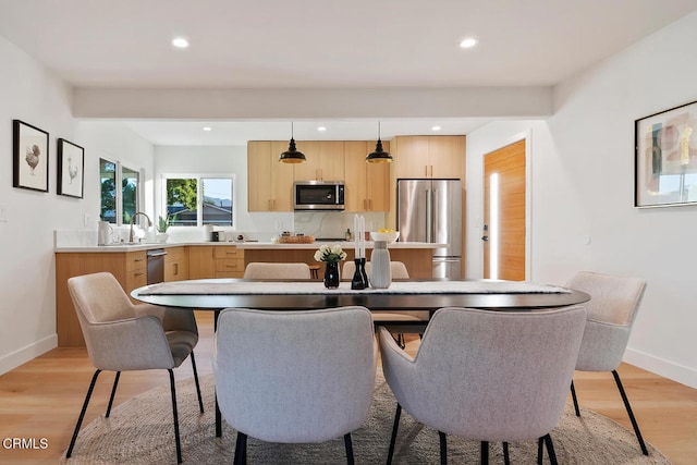 dining room featuring light hardwood / wood-style flooring and sink