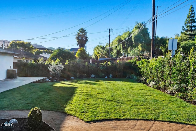 view of yard with a patio and central AC unit