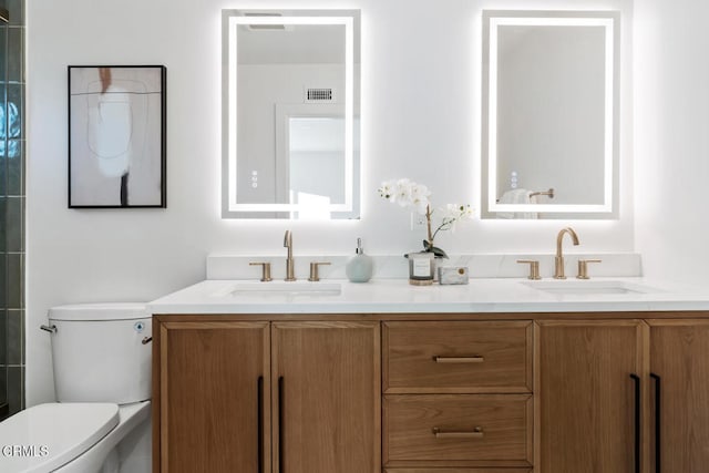 bathroom featuring vanity and toilet