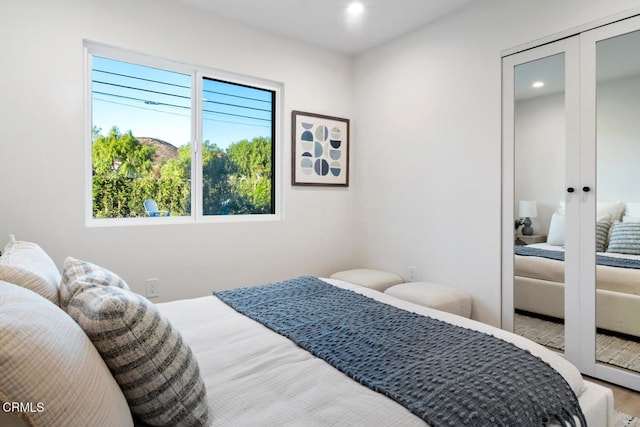 bedroom featuring wood-type flooring and french doors