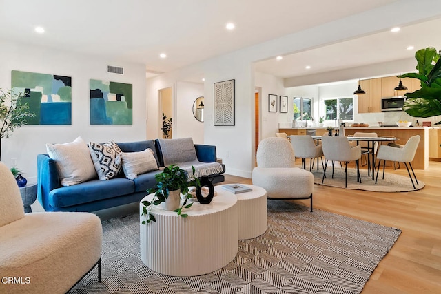 living room with light hardwood / wood-style flooring