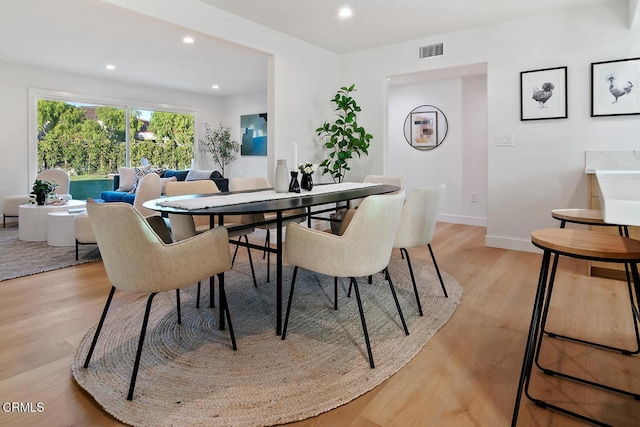 dining space with light hardwood / wood-style flooring