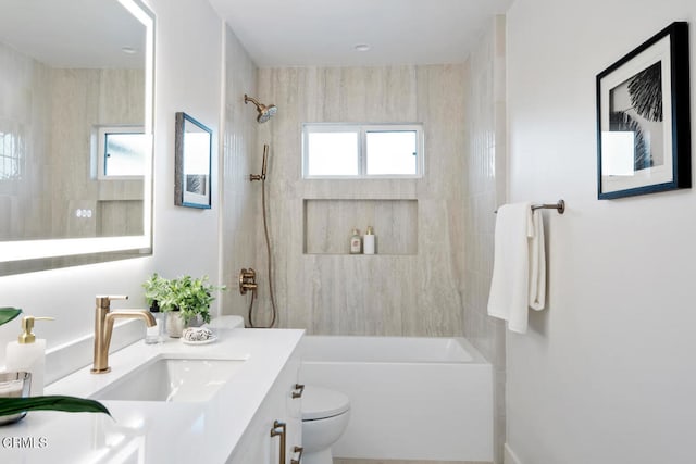 full bathroom featuring plenty of natural light, vanity, tiled shower / bath combo, and toilet