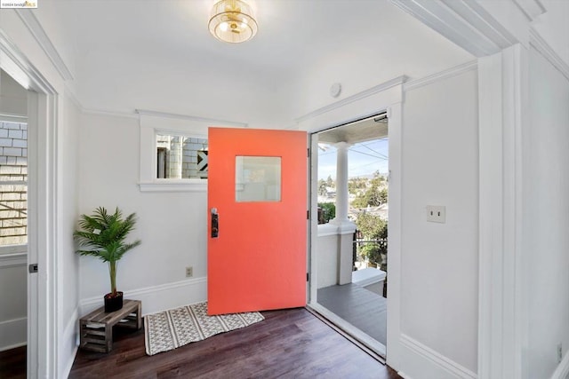 entrance foyer with dark wood-type flooring and ornamental molding