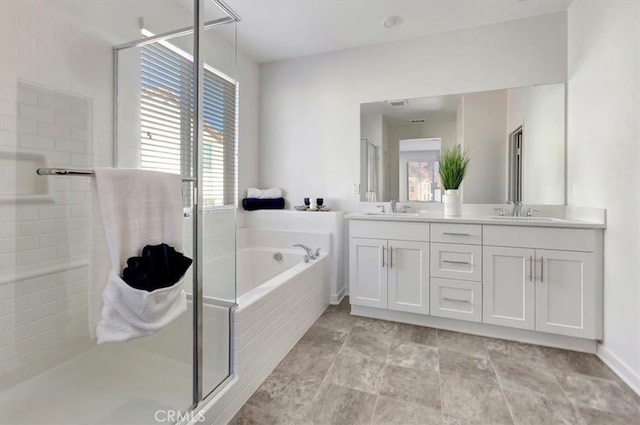 bathroom with vanity, plenty of natural light, and independent shower and bath