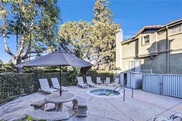 view of pool with a patio area and an in ground hot tub