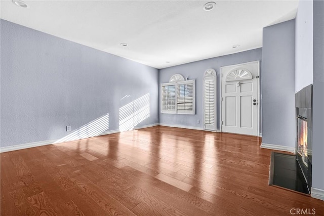 unfurnished living room with hardwood / wood-style floors