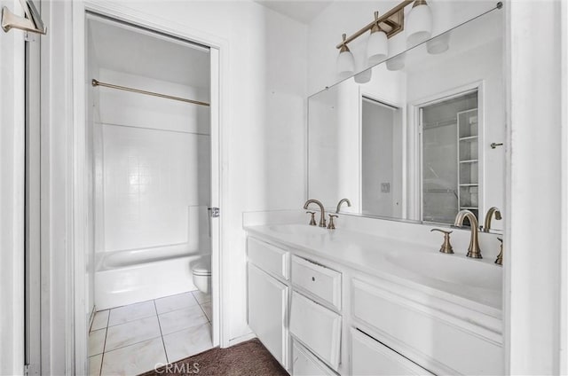 full bathroom featuring toilet, vanity, tile patterned floors, and tub / shower combination