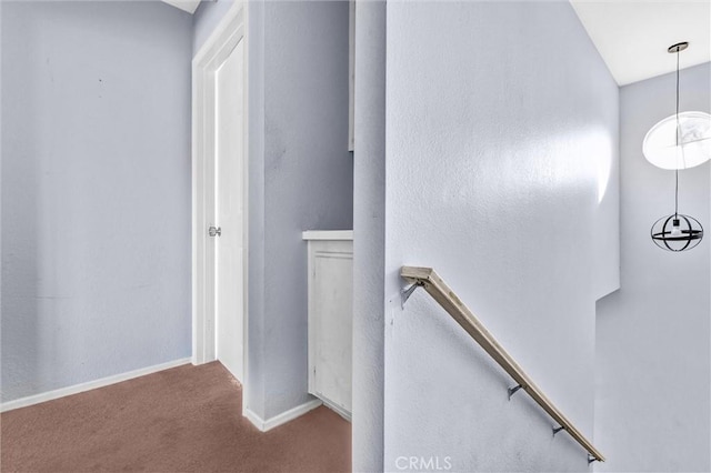 stairway featuring carpet flooring and vaulted ceiling