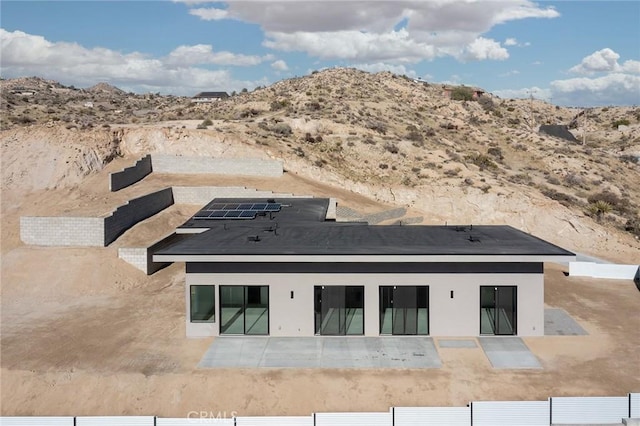 rear view of property featuring a mountain view and a patio