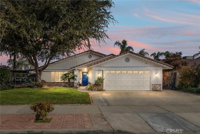 view of front of property featuring a lawn and a garage