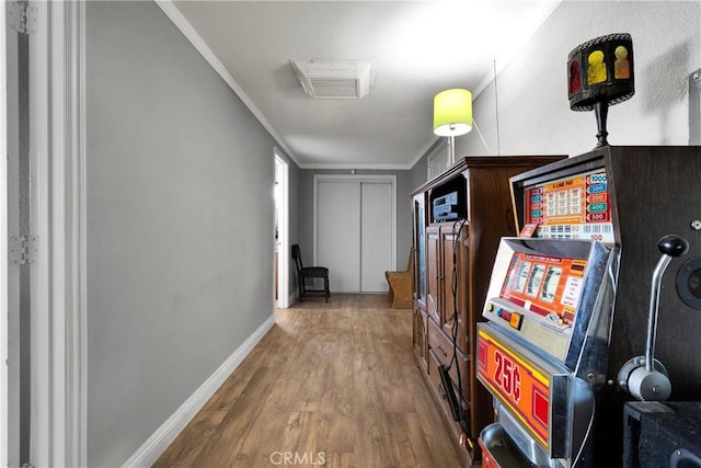 corridor featuring hardwood / wood-style flooring and ornamental molding