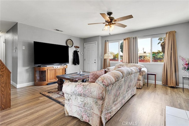 living room featuring ceiling fan and light wood-type flooring