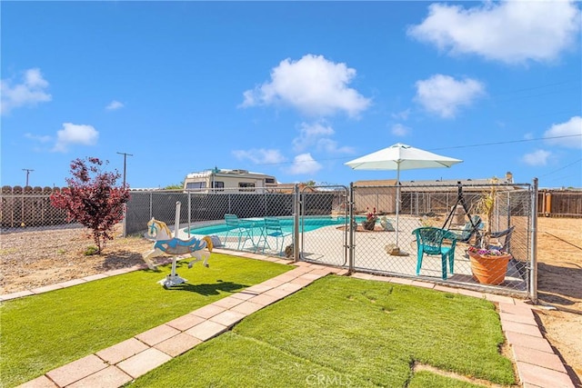 view of pool with a patio area and a lawn