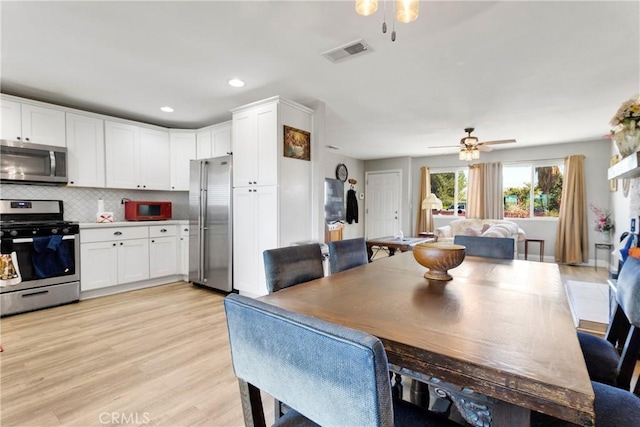dining space featuring ceiling fan and light hardwood / wood-style flooring