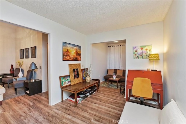 sitting room featuring hardwood / wood-style floors and a textured ceiling