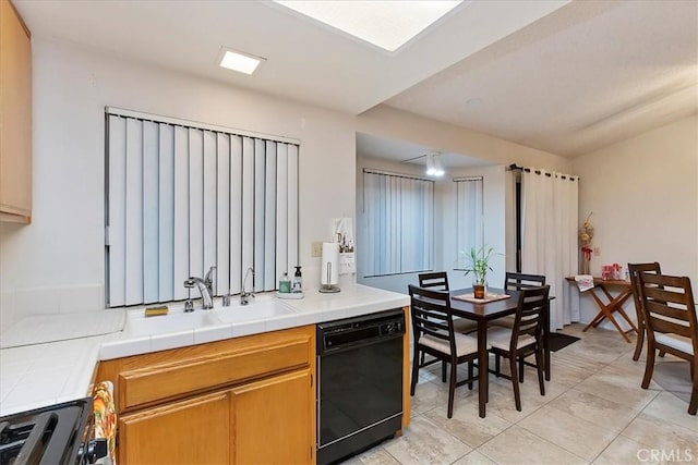 kitchen with tile countertops, dishwasher, sink, and stainless steel stove