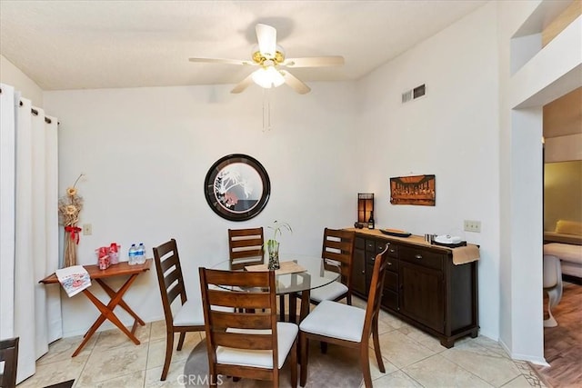 dining space with ceiling fan and light tile patterned floors