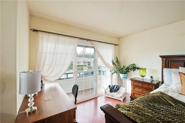 bedroom featuring wood-type flooring and access to outside