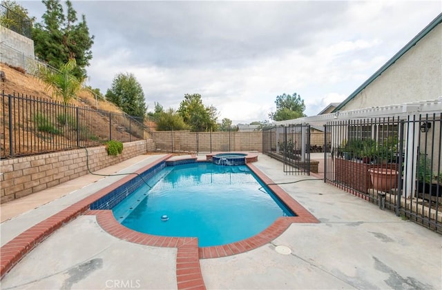 view of pool with an in ground hot tub and a patio