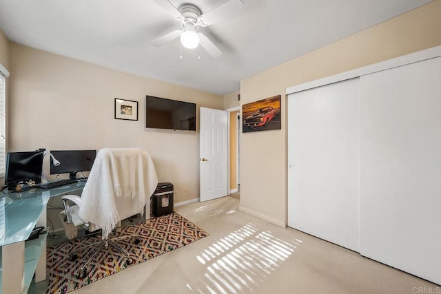 carpeted home office with ceiling fan