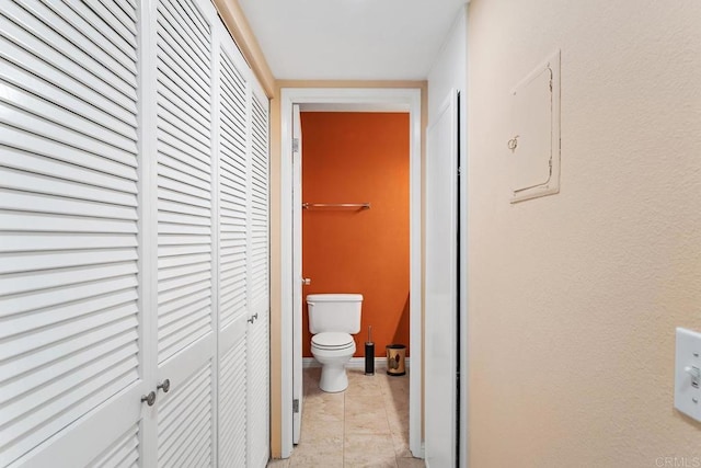 interior space with tile patterned flooring and toilet