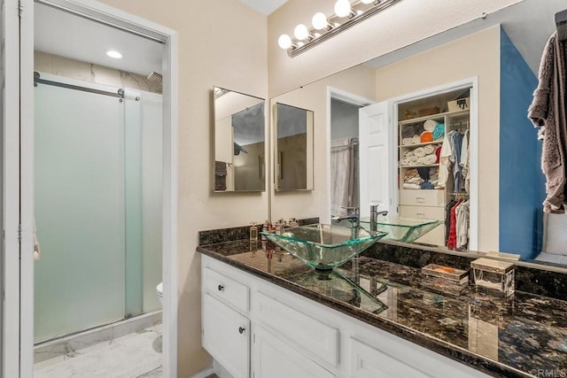 bathroom with vanity, toilet, and walk in shower