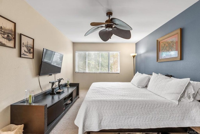 bedroom with light carpet and ceiling fan