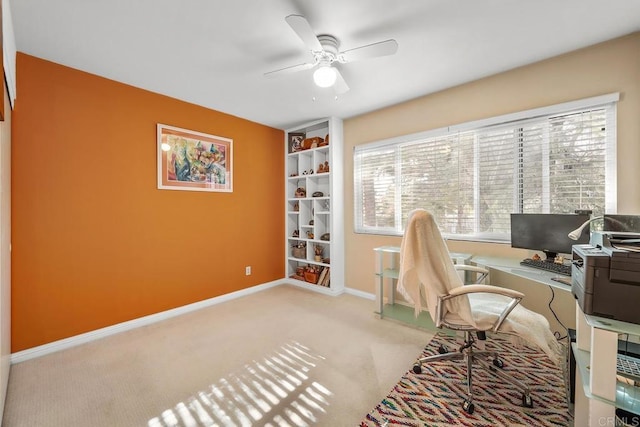 carpeted office space featuring ceiling fan