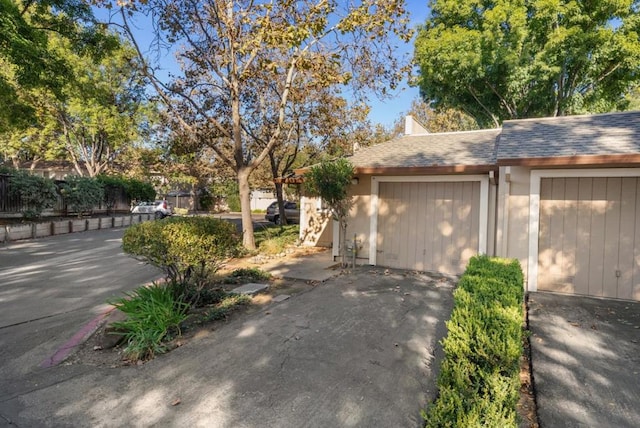 exterior space featuring a garage and an outbuilding