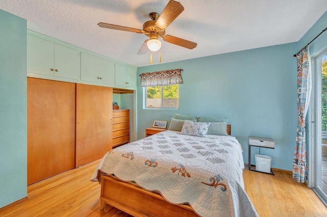 bedroom featuring multiple windows, light hardwood / wood-style floors, and a closet