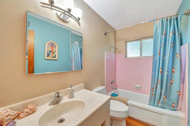 full bathroom featuring vanity, shower / bathtub combination with curtain, and toilet